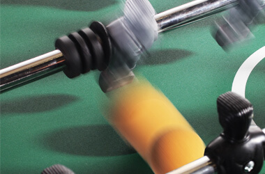 A player making a shot in a game of foosball