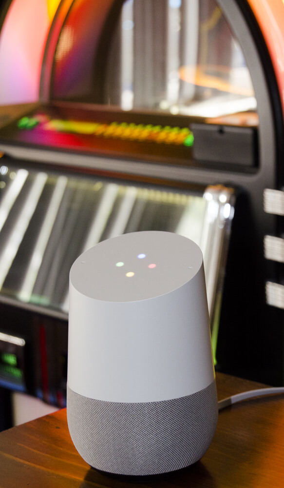 Google home speaker next to a jukebox