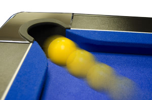 A ball going into a pocket on the Supreme Slimline pool table