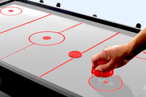 Air hockey played on the Trisport multi games table