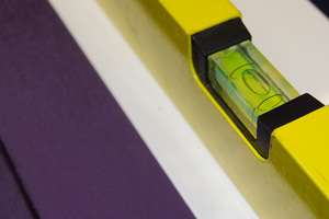 A spirit level being used on a pool table