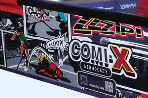 Artwork on the Comix air hockey table