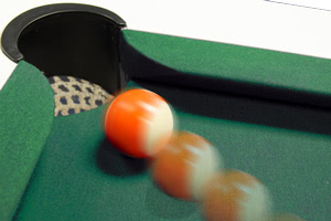 Potting a shot on the Olympus pool table