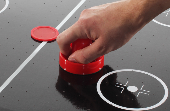 The Tekscore 65mm air hockey puck in play