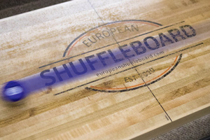 A puck moving across the Gentry shuffleboard table