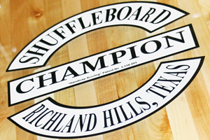 The Champion shuffleboard logo