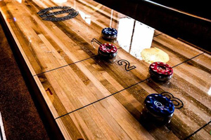 The play field on a Champion shuffleboard table