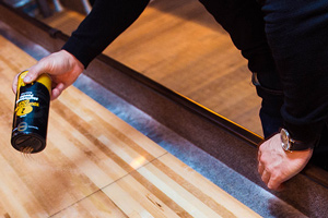 Shuffleboard powder being sprinkled on a table