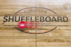 A shot with a shuffleboard puck