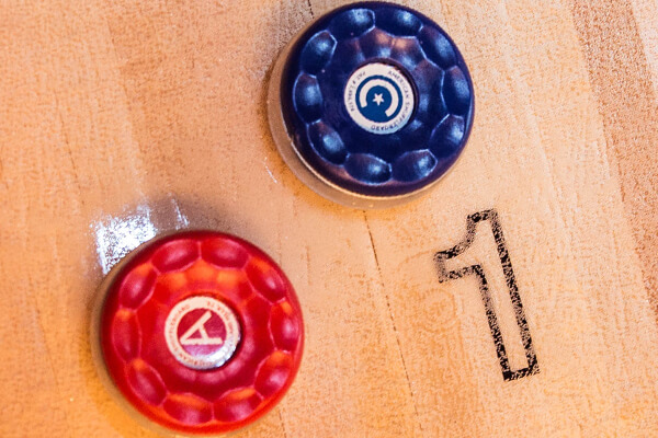 A score with two shuffleboard pucks