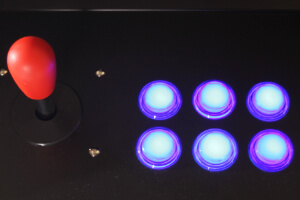 The illuminated fire buttons on the Cosmic arcade.