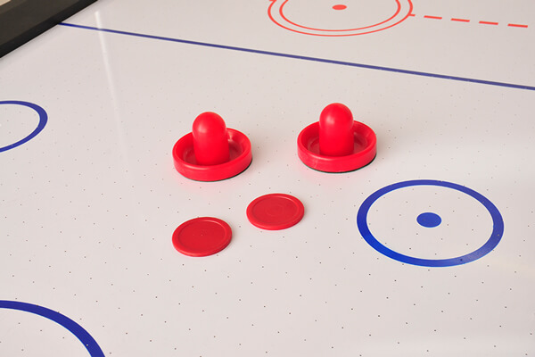 The Sure Shot Super Pro Air Hockey pushers and pucks.
