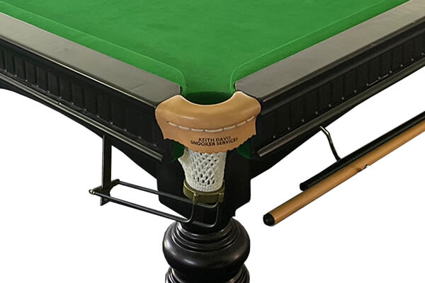 The pocket of a vintage snooker table.