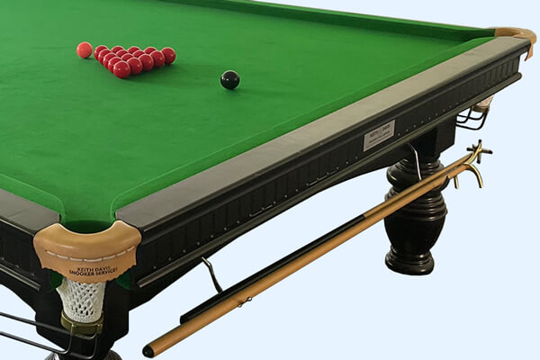 The pocket of a vintage snooker table.