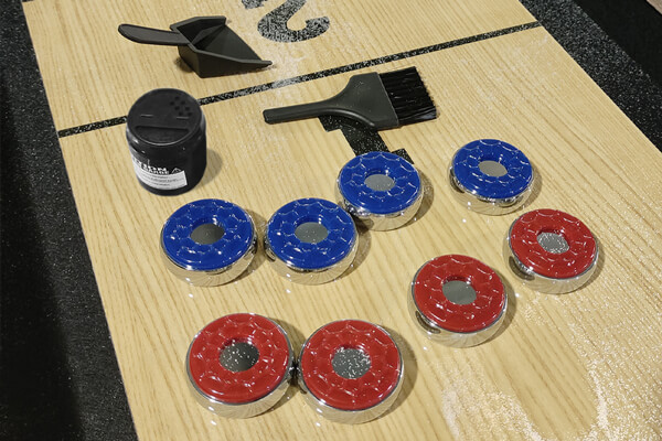 The accessories that come with the Strikeworth Home Shuffleboard.