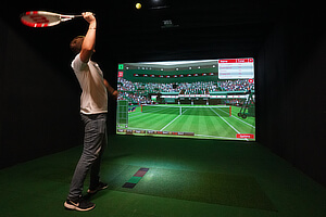 Playing tennis with surround video screens.