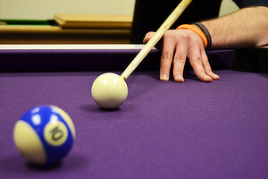 Taking a shot with the Liberty Ash pool cue.