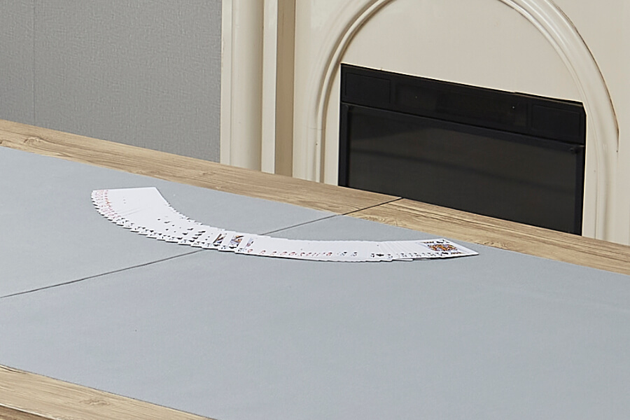 Playing cards on the Rustic Chic card table top.