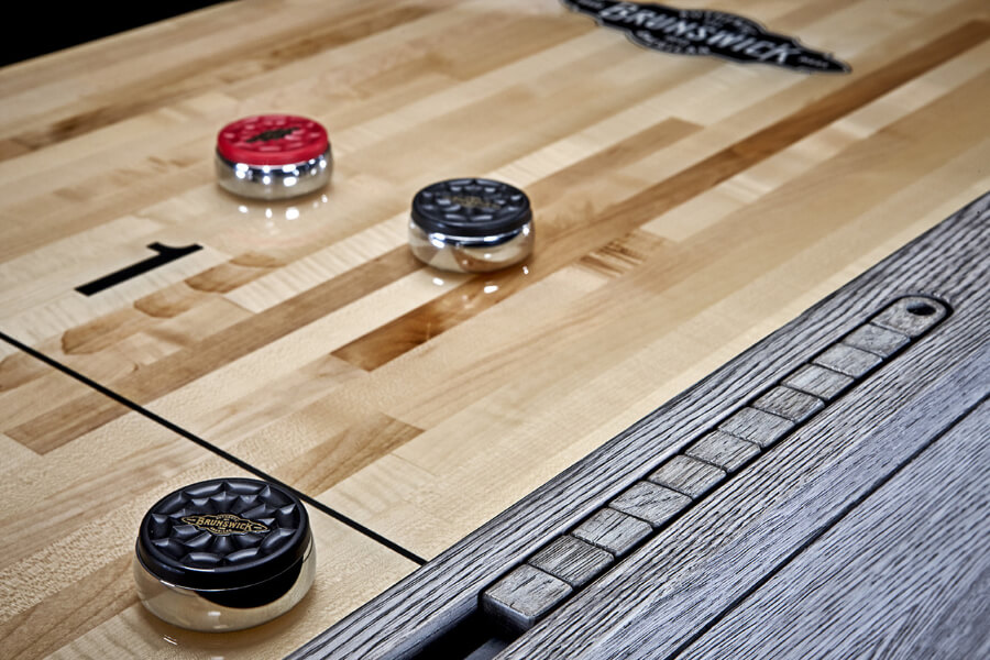 The Sanibel Shuffleboard Table with Included Accessories.