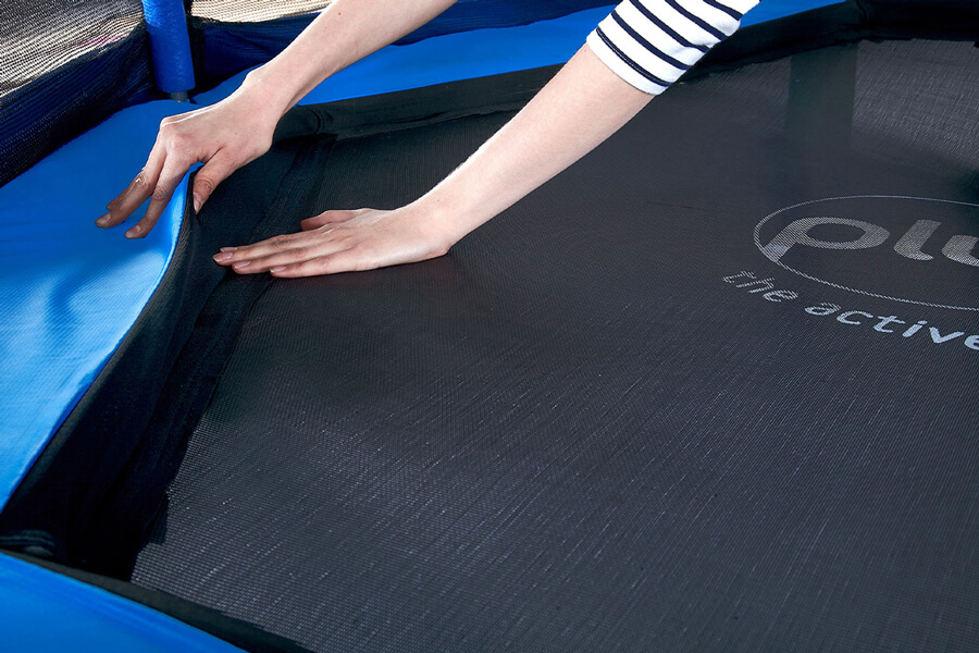 The Plum 7ft Junior Jumper Springsafe trampoline and enclosure in blue and green.