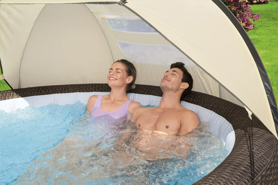 Couple enjoying the Lay-Z-Spa Detachable Hot Tub Canopy.