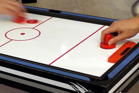 A game of slide hockey on the Tekscore Goal table.