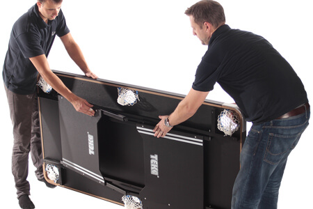 Folding the legs of the Tekscore Folding Pool & Tennis Table.