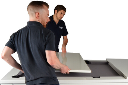 Lifting the top onto a Phoenix pool dining table.