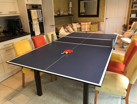 A Tekscore table tennis top on a pool table.