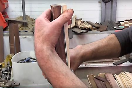 A billiard cue being spliced by hand.
