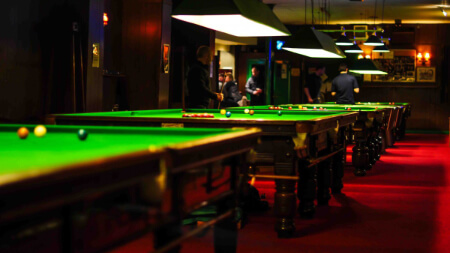 Snooker tables in a commercial snooker hall.