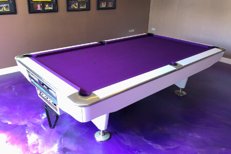 An LA Pro pool table installed on a laminate floor.