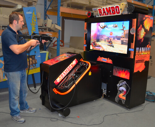 Play-testing the Rambo commercial arcade machine.