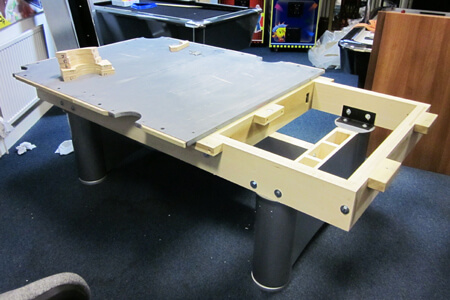 A sectional slate bed being joined during an install.