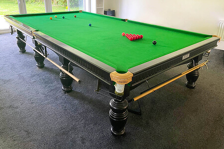 A snooker table fitted with premium snooker cloth.