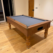 The Monaco in Walnut with grey cloth.