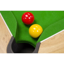 The Strikeworth red & yellow pool balls next to a pocket