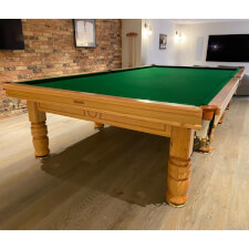 The Tagora Pool table in oak installed in a room.