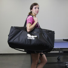 A Girl Carrying The Butterfly Amicus Table Tennis Practice Robot Packed In The Bag.