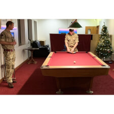 An LA Pro in Wood with Burgundy cloth, installed in a military bar.