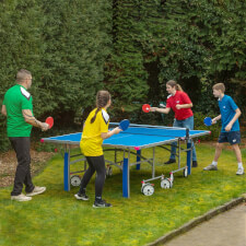 Family playing Butterfly Garden Rollaway 5000 Tennis Table.