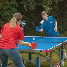 People playing in Butterfly Garden Rollaway 6000 Tennis Table.