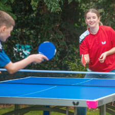 People playing Butterfly Garden Rollaway 7000 Tennis Table.