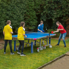 People playing Butterfly Garden Rollaway 7000 Tennis Table.