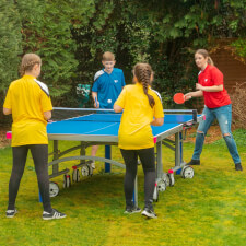 People playing Butterfly Garden Rollaway 7000 Tennis Table.