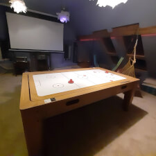 The 7ft Multi Games & Dining Table in Oak set for air hockey.