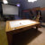 The 7ft Multi Games & Dining Table in Oak set for air hockey.