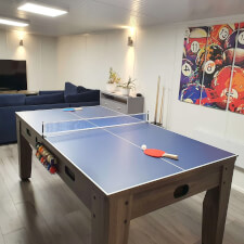 The 7ft Multi Games & Dining Table in Driftwood set for table tennis.