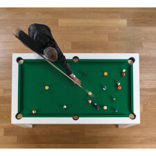 Playing a game on the Cubista pool table.