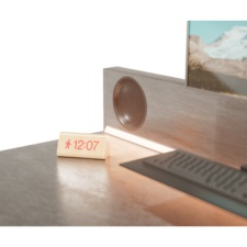 Concept image of the ultimate WFH desk close up with clock and built-in speakers.